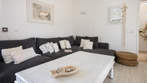 a living room with a black couch and a table at Villa O Canto da Parra - Hot Jacuzzi - Swimming Pool - WIFI - BY BEDZY in Galé