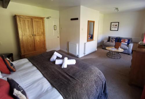 a bedroom with a bed with two crosses on it at The Langstrath Country Inn in Keswick