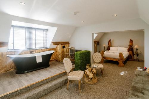 a bedroom with a large bath tub and a bed at Sneaton Castle in Whitby