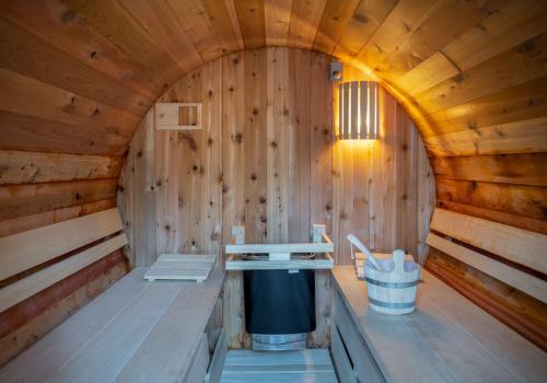 a inside of a wooden sauna with a trash can at ZEN-Bungalow NO 3 met sauna en hottub in Rheezerveen