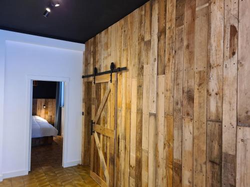 a barn door in a room with a bedroom at Oostduinkerke Apartments in Oostduinkerke