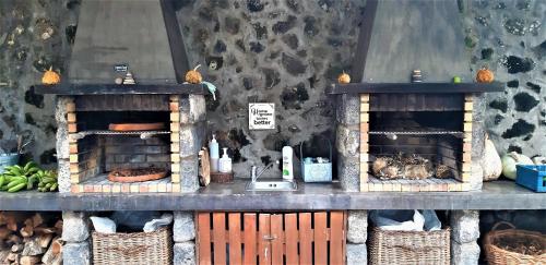 a kitchen with a sink and a counter with baskets at Quinta do Bom Despacho in Ponta Delgada