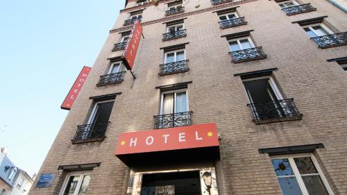 a brick building with a hotel sign on it at Hotel Olympic Paris Boulogne by Patrick Hayat in Boulogne-Billancourt
