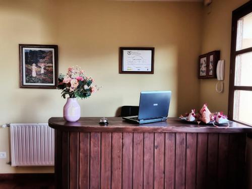 a desk with a laptop computer on top of it at Valle la Fuente in El Escobal