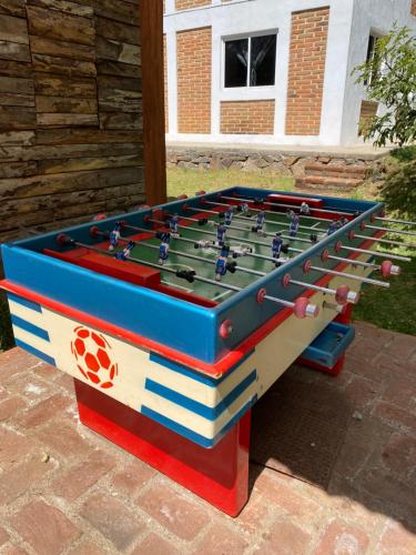 a foosball table with books on top of it at Herradura VIP Inn in Mazamitla