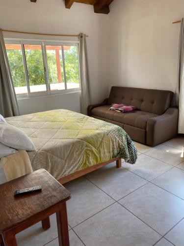 a bedroom with a bed and a couch at Herradura VIP Inn in Mazamitla