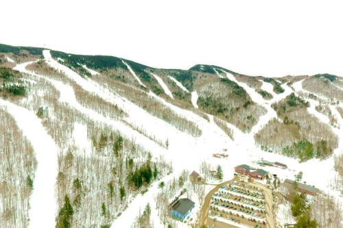 an aerial view of a ski resort on a snow covered mountain at Locke Mountain D1 in Newry