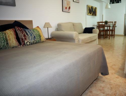 a bedroom with a bed and a living room at Estudio Escobar in Nerja