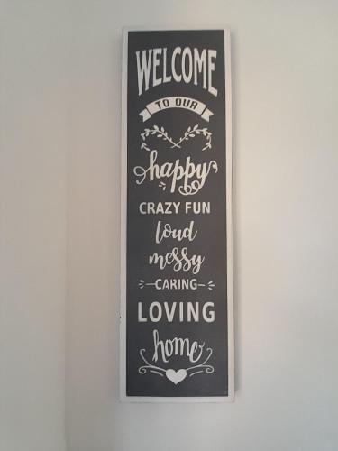 a chalkboard sign that says welcome to our happy happycrazycrazy fun and messy at Doctors lane Stylish 3 Bedroom Family House with Parking in Melton Mowbray
