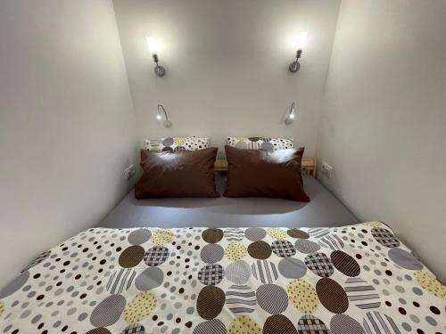 a bedroom with a bed with a polka dot bedspread at Апартаменты #3 in Almaty