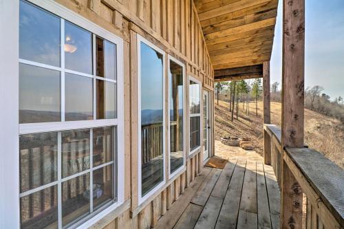 a porch of a wooden house with windows at Peaceful Mountain Air Getaway with Fire Pit! in Mountain View