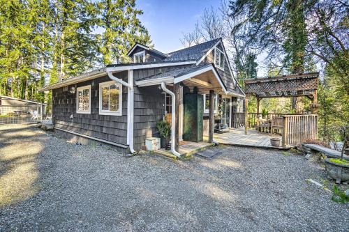 a small house with a porch and a deck at Pet-Friendly Cabin Minutes to Gig Harbor! in Fox Island