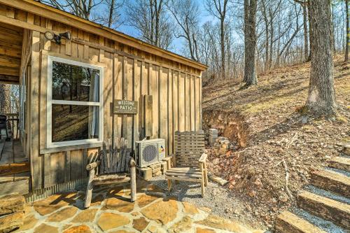 a log cabin with a sign and a chair outside at Peaceful Mountain Air Getaway with Fire Pit! in Mountain View