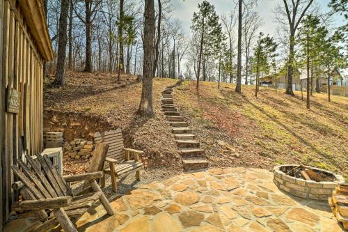 a set of wooden chairs and a tree next to a house at Peaceful Mountain Air Getaway with Fire Pit! in Mountain View