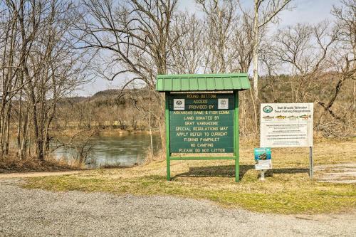 a green sign next to a river with a sign at Peaceful Mountain Air Getaway with Fire Pit! in Mountain View