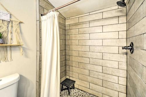 a bathroom with a shower curtain and a toilet at Pet-Friendly Cabin Minutes to Gig Harbor! in Fox Island