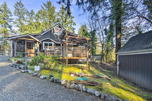 a large wooden house with a gambrel roof at Pet-Friendly Cabin Minutes to Gig Harbor! in Fox Island