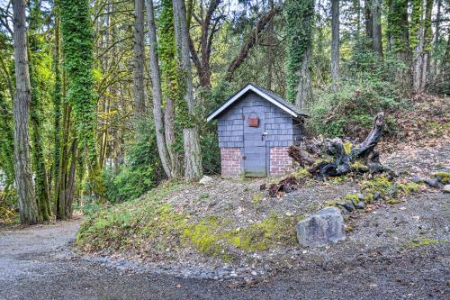 a small house in the middle of a forest at Pet-Friendly Cabin Minutes to Gig Harbor! in Fox Island