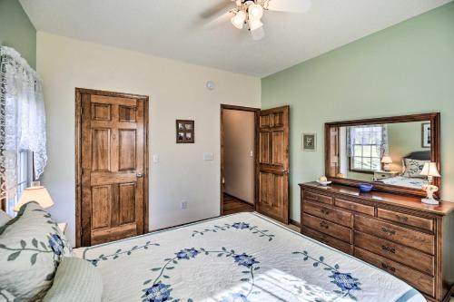 a bedroom with a bed and a dresser and a mirror at Pet-Friendly Abingdon Abode with Yard and Grill! in Abingdon