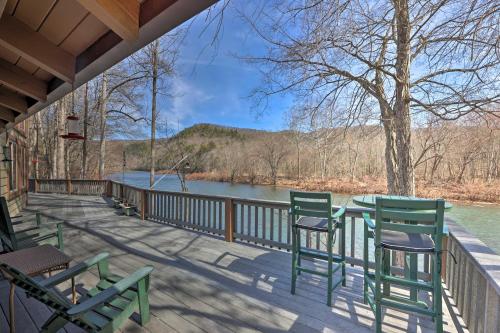 a deck with chairs and a table with a view of a river at Serenity on the River Luxe Lewisburg Cabin! in Lewisburg