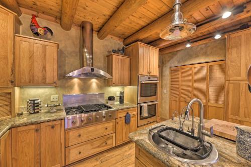 a kitchen with a sink and a stove top oven at Serenity on the River Luxe Lewisburg Cabin! in Lewisburg