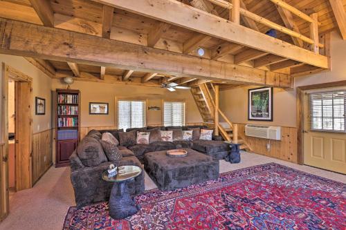 a living room with a couch and a table at Serenity on the River Luxe Lewisburg Cabin! in Lewisburg