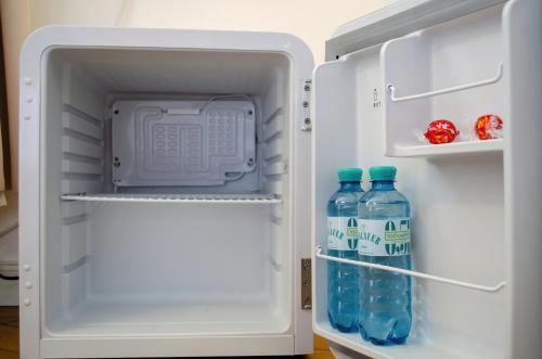 an open refrigerator with two bottles of water in it at HOMELY STAY Studio 5 in Munich