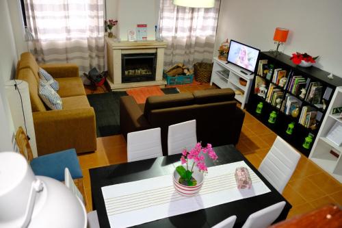 a living room with a table and a couch at Apartamento Alegria in Arouca