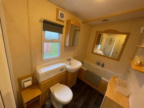 a small bathroom with a sink and a toilet at Reighton Sands 2 in Filey