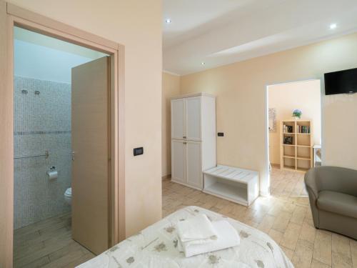 a bathroom with a shower and a bed in a room at Affittacamere Lunamar in La Spezia