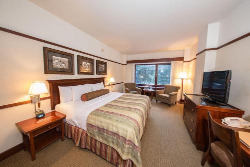 a hotel room with two beds and a television at Alyeska Resort in Girdwood