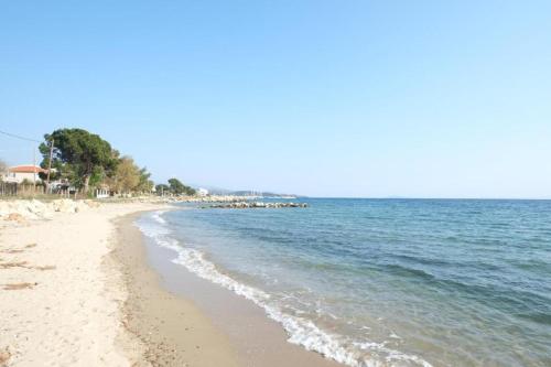 a sandy beach with the ocean in the background at Villa Valerie in Nikiti
