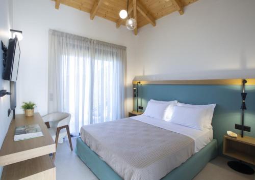 a bedroom with a large bed and a desk and a bed sidx sidx sidx sidx at Inorato - Luxury Villa with Private Swimming Pool in Kalamitsi