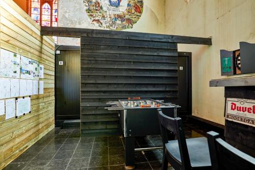 a room with a chess board on a table at Sleeping in a Church - Bed & Bar Tolomeus in Diksmuide