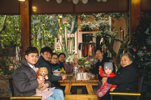 a group of people sitting at a table in a restaurant at Trang An Village Homestay in Ninh Binh