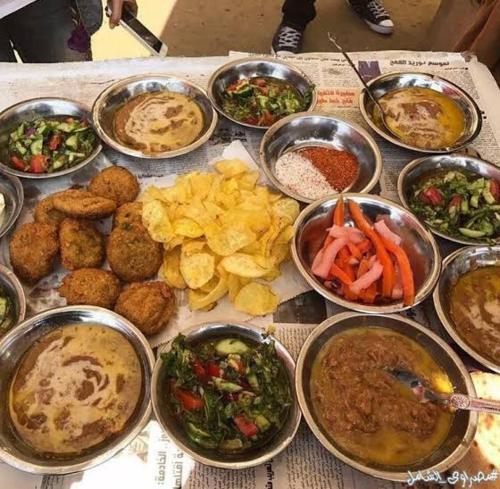 a table topped with bowls of different types of food at Valley Of The Kings House in Luxor