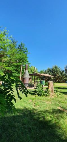 a green field with a building with a bell tower at Rancho Por Fin in Barreal