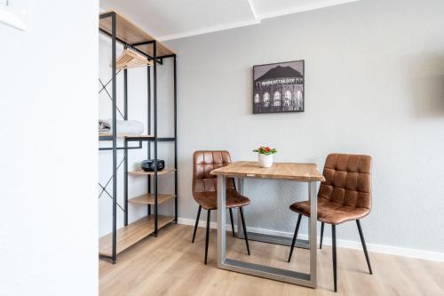 a dining room with a table and two chairs at Wohnen auf Zeit - Innenstadt-Appartements in Freiburg im Breisgau