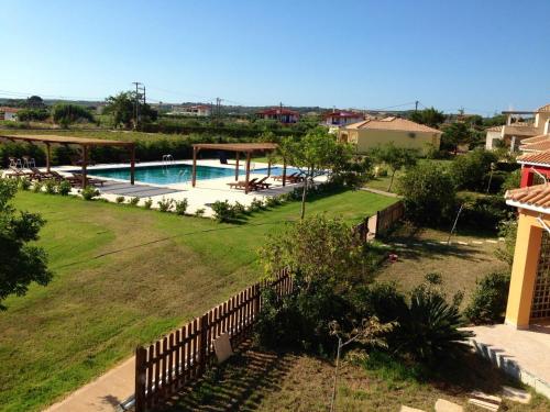 a view of a yard with a swimming pool at Boutique Hotel Ileas Village in Arkoudi