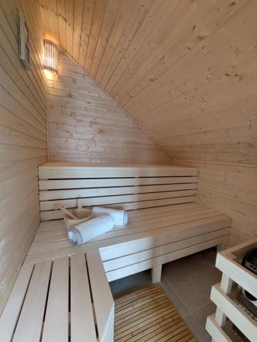 a sauna with a bench and a sink at BEe in foREST in Pivka