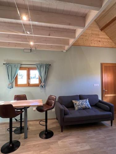 a living room with a couch and a table at Chalets "Ô Cœur des Puys" in Ceyssat
