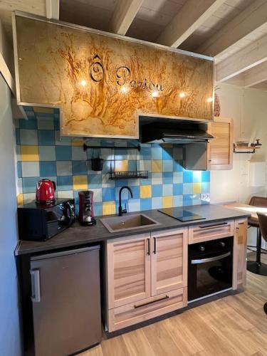 a kitchen with a sink and a counter top at Chalets "Ô Cœur des Puys" in Ceyssat