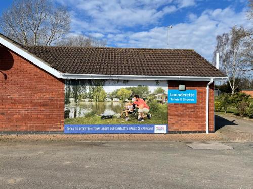 a building with a large window with a picture of a person riding a horse at private rented caravan situated at Southview holiday park in Winthorpe