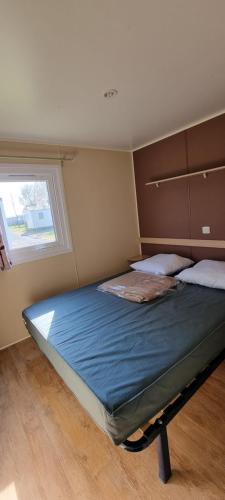 En eller flere senge i et værelse på Mobil Home Camping les Almadies Nouveau nom Aunis Club Vendée