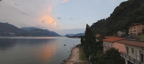 a view of a body of water with houses and mountains at Miralago Casa in Menaggio