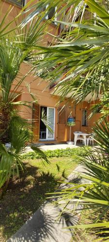 a house with palm trees in front of it at Miralago Casa in Menaggio