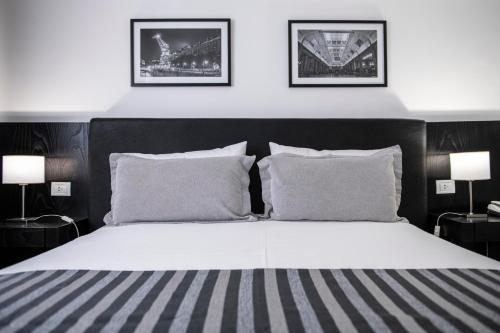 a bedroom with a large bed with two pillows at Grand King Hotel in Buenos Aires