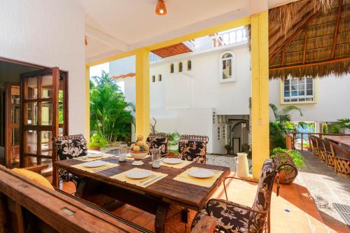 a wooden table and chairs on a patio at Villas Jardin Del Mar in Cruz de Huanacaxtle
