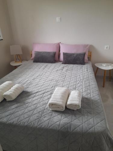 a large bed with two white pillows on it at Sunrise Apartment 2 in Souda