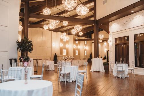 a banquet hall with white tables and chairs and chandeliers at Crowne Plaza Providence-Warwick (Airport) by IHG in Warwick